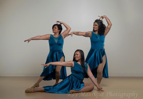 Desueño team members pose in teal costumes