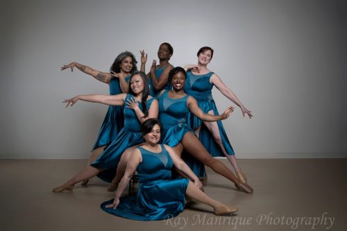 Desueño team members pose in teal costumes