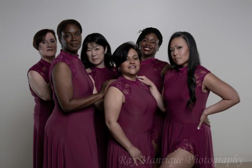 Desueño team members pose in berry Perception costumes
